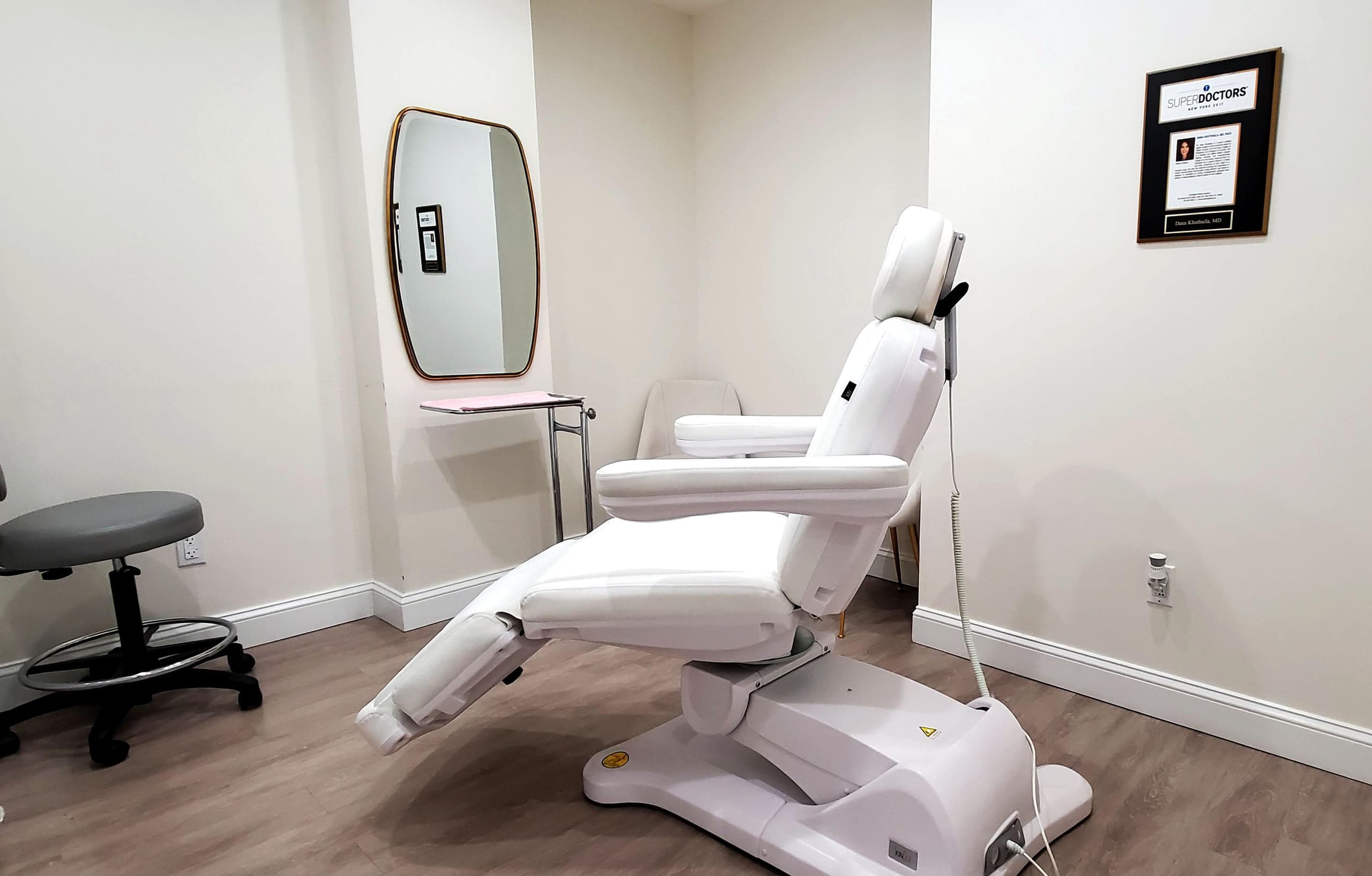 A treatment room with an examination chair at Hudson Face & Eye